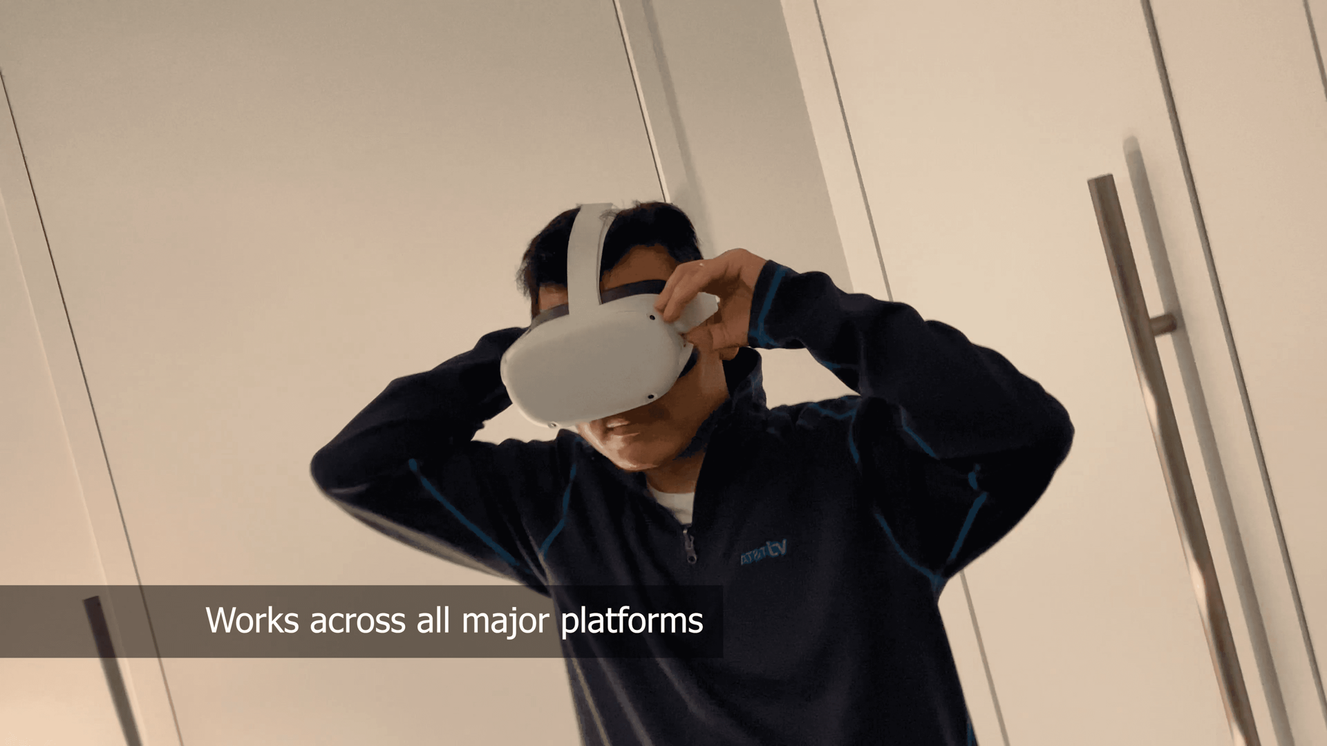 A person putting on a virtual-reality headset, captioned “Works across all major platforms”.